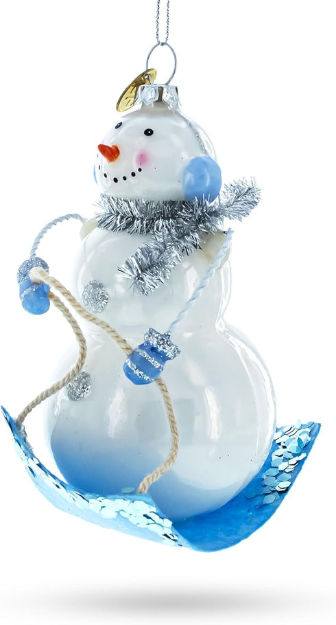 Snowman Riding a Sled - Blown Glass Christmas Ornament