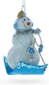 Snowman Riding a Sled - Blown Glass Christmas Ornament
