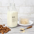 DHSBTLS 4 Pcs Glass Milk Bottles - 33.8 Oz Reusable Containers with Lid for Fridge, Airtight Heavy Duty Juice Jar
