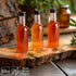 Mini Plastic Bottles with Lids (24 Pack) - Empty 1.7oz Shot Bottles for Alcohol, Spirits, Liquor - Funnel Included