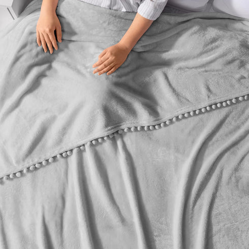 PAVILIA Light Grey Fleece Throw Blanket for Couch, 60x80 Inches, Soft Cozy Fuzzy Flannel Blanket with Pom Pom Fringe