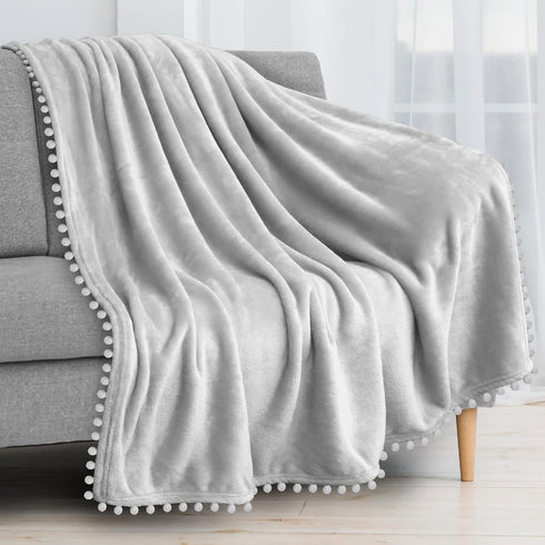 PAVILIA Light Grey Fleece Throw Blanket for Couch, 60x80 Inches, Soft Cozy Fuzzy Flannel Blanket with Pom Pom Fringe