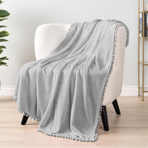 PAVILIA Light Grey Fleece Throw Blanket for Couch, 60x80 Inches, Soft Cozy Fuzzy Flannel Blanket with Pom Pom Fringe