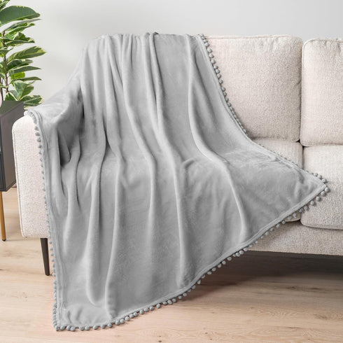 PAVILIA Light Grey Fleece Throw Blanket for Couch, 60x80 Inches, Soft Cozy Fuzzy Flannel Blanket with Pom Pom Fringe