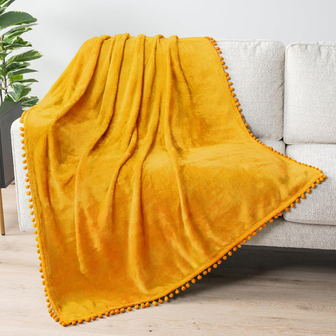 PAVILIA Fleece Throw Blanket for Couch with Pom Pom Fringe, Mustard Yellow,